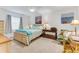 Relaxing bedroom with a queen bed, ceiling fan, side table, and writing desk at 484 Sweet Bay Ave, New Smyrna Beach, FL 32168
