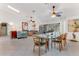 Open concept dining area with modern glass table and chairs, leading to a bright living space at 484 Sweet Bay Ave, New Smyrna Beach, FL 32168