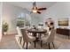 Elegant dining room with a round table, six chairs, and a stylish chandelier at 484 Sweet Bay Ave, New Smyrna Beach, FL 32168