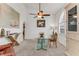 Bright dining room featuring a glass table, modern ceiling fan, and a large cabinet at 484 Sweet Bay Ave, New Smyrna Beach, FL 32168