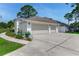 Beautiful one-story home featuring a three-car garage, and well-manicured lawn at 484 Sweet Bay Ave, New Smyrna Beach, FL 32168