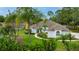 Inviting single-story home with lush landscaping and well-maintained lawn surrounded by mature trees at 484 Sweet Bay Ave, New Smyrna Beach, FL 32168