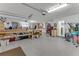 Bright and spacious garage providing ample storage, work areas, and access to the laundry room at 484 Sweet Bay Ave, New Smyrna Beach, FL 32168