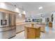 Spacious kitchen featuring stainless steel refrigerator, light wood cabinets, and central island at 484 Sweet Bay Ave, New Smyrna Beach, FL 32168