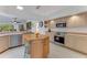 Open-concept kitchen with stainless steel appliances, light wood cabinets, and a central island at 484 Sweet Bay Ave, New Smyrna Beach, FL 32168