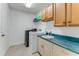 Functional laundry room with modern washer and dryer, ample counter space, and cabinet storage at 484 Sweet Bay Ave, New Smyrna Beach, FL 32168