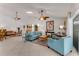 Spacious living room featuring tiled floors, skylight, and stylish blue furniture for a cozy atmosphere at 484 Sweet Bay Ave, New Smyrna Beach, FL 32168