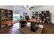 Well-appointed office featuring a spacious desk, bookshelves, and natural light for a productive workspace at 484 Sweet Bay Ave, New Smyrna Beach, FL 32168