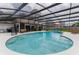 Huge screened-in pool with steps, blue water, lounge chairs, and a barbecue grill at 484 Sweet Bay Ave, New Smyrna Beach, FL 32168