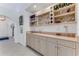 Elegant wet bar with custom cabinetry, sink, and ample storage for glassware and beverages at 484 Sweet Bay Ave, New Smyrna Beach, FL 32168