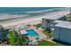 Aerial view of condo complex with beach access, pool, and well-kept green spaces at 4849 Saxon # C202, New Smyrna Beach, FL 32169