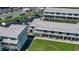 Aerial view showcasing condo complex with balconies, green spaces, and convenient parking at 4849 Saxon # C202, New Smyrna Beach, FL 32169