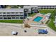 Aerial view of beachfront condo complex with pool, beach access, and well-maintained green spaces at 4849 Saxon # C202, New Smyrna Beach, FL 32169