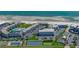 Aerial view showing a condo complex with pools, beach access, parking, and tennis courts at 4849 Saxon # C202, New Smyrna Beach, FL 32169