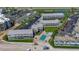 Aerial view of condo complex featuring parking, tennis courts, a pool, and direct beach access at 4849 Saxon # C202, New Smyrna Beach, FL 32169