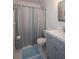 Neat bathroom featuring a vanity with storage, modern fixtures, and a shower with a tasteful curtain at 4849 Saxon # C202, New Smyrna Beach, FL 32169