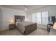 Comfortable bedroom with a large window, ceiling fan and neutral tones, perfect for relaxation at 4849 Saxon # C202, New Smyrna Beach, FL 32169