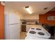 Efficient kitchen featuring white cabinets, neutral countertops, and essential appliances at 4849 Saxon # C202, New Smyrna Beach, FL 32169