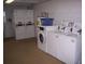 Brightly lit laundry room equipped with multiple high-efficiency washers and dryers for resident convenience at 4849 Saxon # C202, New Smyrna Beach, FL 32169