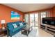Comfortable living room with modern furnishings, access to a balcony, and natural light at 4849 Saxon # C202, New Smyrna Beach, FL 32169