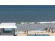 Breathtaking ocean view with a pool and sandy beach perfect for relaxation and seaside fun at 4849 Saxon # C202, New Smyrna Beach, FL 32169