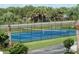 Outdoor community tennis court with well-maintained playing surface and surrounding landscaping at 4849 Saxon # C202, New Smyrna Beach, FL 32169