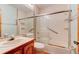 Bathroom with tiled shower, wood-look floors, and a matching vanity at 488 Shorewood Ln, New Smyrna Beach, FL 32168