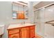 Tiled bathroom featuring a glass-enclosed shower and a wood vanity with ample storage at 488 Shorewood Ln, New Smyrna Beach, FL 32168