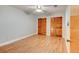 Spacious bedroom featuring wood-look floors and double closets with paneled doors at 488 Shorewood Ln, New Smyrna Beach, FL 32168