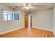 Well-lit bedroom with wood-look flooring, ceiling fan, and a large window at 488 Shorewood Ln, New Smyrna Beach, FL 32168