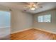 Bedroom with laminate floors, ceiling fan, and a window overlooking the community at 488 Shorewood Ln, New Smyrna Beach, FL 32168