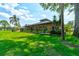 Beautiful clubhouse surrounded by lush green lawns and tropical palm trees, creating a resort-like atmosphere at 488 Shorewood Ln, New Smyrna Beach, FL 32168