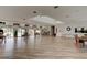 Spacious clubhouse interior with wood floors, tables, chairs, and ample natural light at 488 Shorewood Ln, New Smyrna Beach, FL 32168