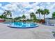 The community pool has a hot tub and is surrounded by palm trees and lounge chairs at 488 Shorewood Ln, New Smyrna Beach, FL 32168