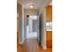 Inviting entryway with a view of the tiled porch, and warm wooden floors lead into the kitchen at 488 Shorewood Ln, New Smyrna Beach, FL 32168