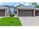 Charming townhome featuring a private two-car garage, stone accents, and a well-maintained lawn at 488 Shorewood Ln, New Smyrna Beach, FL 32168
