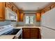 Well-lit kitchen featuring ample cabinet space, white countertops, and appliances, with a view of the backyard at 488 Shorewood Ln, New Smyrna Beach, FL 32168