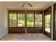 Enclosed lanai overlooking a serene pond with a fountain and lush landscaping at 488 Shorewood Ln, New Smyrna Beach, FL 32168