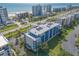 Aerial view showcasing condo building's well-maintained landscaping, ample parking, and a peek of the ocean at 5300 S Atlantic Ave # 1-603, New Smyrna Beach, FL 32169