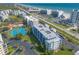 Aerial view of condos with tennis courts, and a pool near the beach and Intracoastal Waterway at 5300 S Atlantic Ave # 1-603, New Smyrna Beach, FL 32169