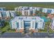 Beautiful aerial view of a multi-Gathering residential building with lush green surroundings and ample parking at 5300 S Atlantic Ave # 1-603, New Smyrna Beach, FL 32169