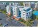 Aerial view of the building featuring ample parking, landscaping and other nearby buildings at 5300 S Atlantic Ave # 1-603, New Smyrna Beach, FL 32169