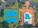 Aerial view of tennis courts, shuffleboard, and a blue pool in a beautiful landscaped location at 5300 S Atlantic Ave # 1-603, New Smyrna Beach, FL 32169