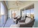 Relaxing balcony with patio chairs, ceiling fan, and sliding glass doors overlooking the city at 5300 S Atlantic Ave # 1-603, New Smyrna Beach, FL 32169
