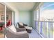 A cozy balcony with outdoor seating and views of the surrounding area at 5300 S Atlantic Ave # 1-603, New Smyrna Beach, FL 32169