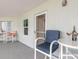 Relaxing balcony setting with outdoor seating and a table with wine and glasses at 5300 S Atlantic Ave # 1-603, New Smyrna Beach, FL 32169
