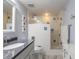 Updated bathroom featuring glass enclosed shower, white tiling, and modern fixtures at 5300 S Atlantic Ave # 1-603, New Smyrna Beach, FL 32169