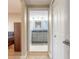 An open doorway reveals a bathroom with double sinks, a granite countertop, and modern cabinets at 5300 S Atlantic Ave # 1-603, New Smyrna Beach, FL 32169
