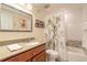 Well-lit bathroom featuring a modern vanity, framed mirror and a shower tub combo at 5300 S Atlantic Ave # 1-603, New Smyrna Beach, FL 32169