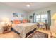 Bright bedroom featuring a cozy bed, a ceiling fan and a work space with ocean views at 5300 S Atlantic Ave # 1-603, New Smyrna Beach, FL 32169